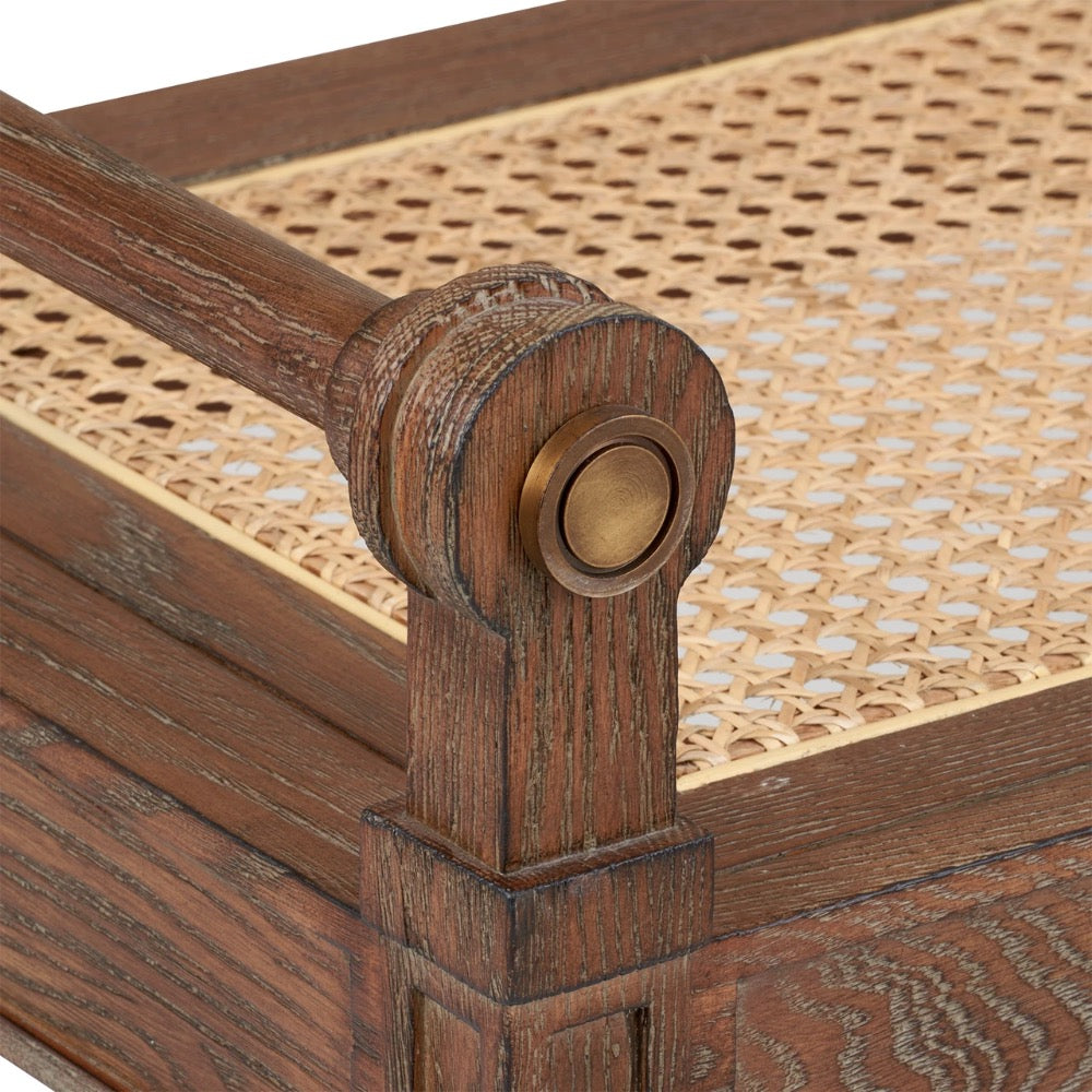 Close-up of a wooden bench with woven cane top