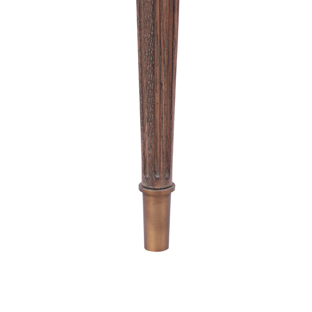 Close-up of a dark brown fluted wooden post or finial with a bronze metal cap, shown vertically against a plain white background.