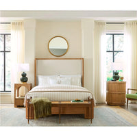 A mid-century modern wooden bed frame with a tall upholstered headboard, styled in a bright, neutral-toned bedroom with cream curtains, a wooden bench, and matching nightstands.