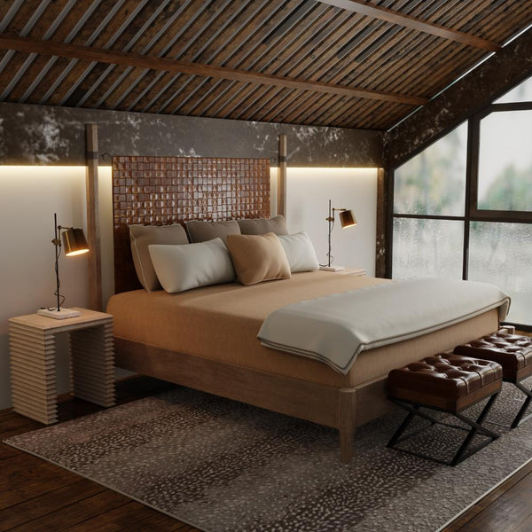 A cozy attic bedroom with a Sarreid, Ltd. Vineyards Leather Headboard King Bed and modern pine veneer decor.