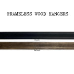 The Art Print Frameless Wood + Steel Hangers from Barloga Studios are displayed in two finishes: black and walnut. Ideal for displaying modern art prints, these elegant hangers seamlessly integrate into any decor while highlighting artwork with a sleek contemporary touch.
