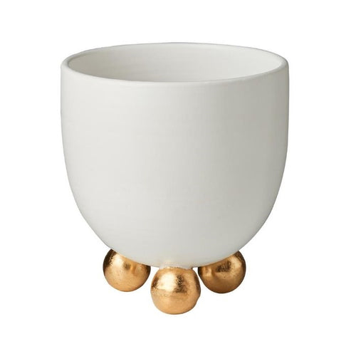 The Catalina Gold Footed Cachepot by Abigails is a matte white ceramic piece with four gold accents, handmade in Italy.