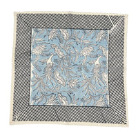 Set of 4 square napkins named Flowers + Feathers Cabana from Abigails, featuring a blue and white birds and flowers pattern, bordered by black and white diagonal stripes.