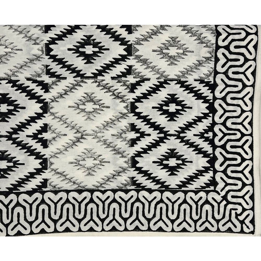 The Yellowstone Cabana Tablecloth by Abigails features a black and white tribal pattern with diamond shapes and an intricate border design, making it perfect for creating 100% cotton napkins.