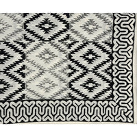 The Yellowstone Cabana Tablecloth by Abigails features a black and white tribal pattern with diamond shapes and an intricate border design, making it perfect for creating 100% cotton napkins.