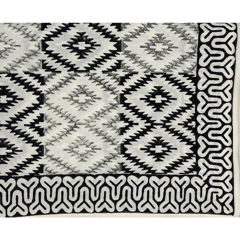 The Yellowstone Cabana Tablecloth by Abigails features a black and white tribal pattern with diamond shapes and an intricate border design, making it perfect for creating 100% cotton napkins.