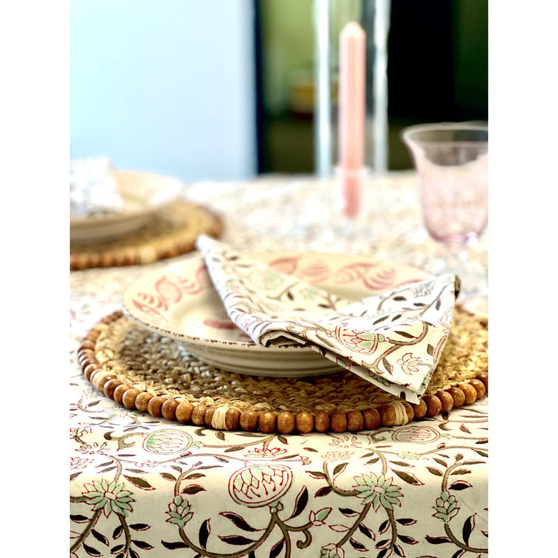 Create an elegant table setting with a floral-patterned tablecloth, matching napkins, woven placemats, and a pink candle. Add charm with Majolica ceramics and enhance the warm ambiance using the Casa Nuno Pink Dinner Plates by Abigails (set of 2).