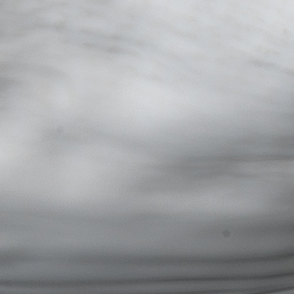 A close-up of the Peony Ceramic Bowl by Jamie Young reveals swirling patterns of gray and white, reminiscent of delicate flower petals.