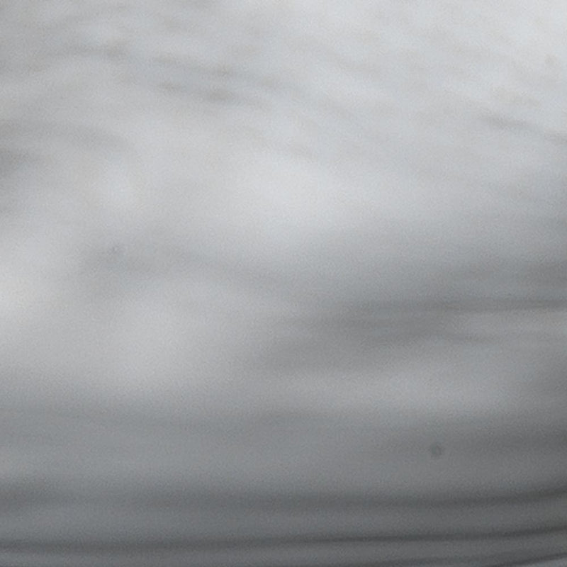 A close-up of the Peony Ceramic Bowl by Jamie Young reveals swirling patterns of gray and white, reminiscent of delicate flower petals.