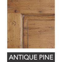 A close-up of a Jullian King Caned Headboard Bed by Phillips Scott features a label reading "Antique Pine" underneath, highlighting its elegant shell white finish.