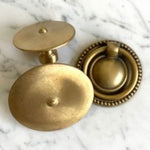 A Bentley Drawer Buffet by Phillips Scott with two brass knobs: one flat, the other beaded.