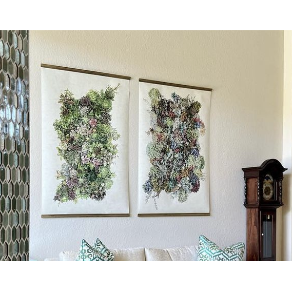 Two Barloga Studios Collective Hydrangeas photos with pillows; a hexagonal mirror and wooden clock are nearby.