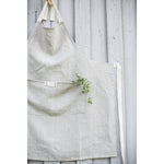 Natural oatmeal linen apron with pocket for casual entertaining.  Farmhouse style that is machine washable.