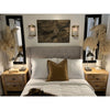 Cozy bedroom with a tufted headboard, wooden nightstands, and Kalalou's Glass + Antique Brass Candle Wall Sconces.