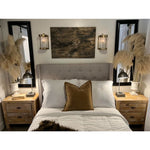 Cozy bedroom with a tufted headboard, wooden nightstands, and Kalalou's Glass + Antique Brass Candle Wall Sconces.