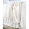 white knitted throw tassels
