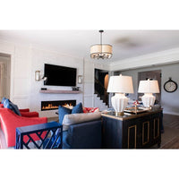 Modern living room with a TV, fireplace, colorful sofas, and Kalalou candle wall sconces by the staircase.