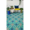 Stylish room with geometric blue tiles, a yellow bench, plants, and decor on a Spicher and Company vinyl floorcloth.