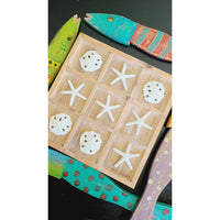 Kalalou's Tic-Tac-Toe Seaside Game offers a beach-inspired experience with starfish and sand dollar pieces, complemented by vibrant fish decorations.