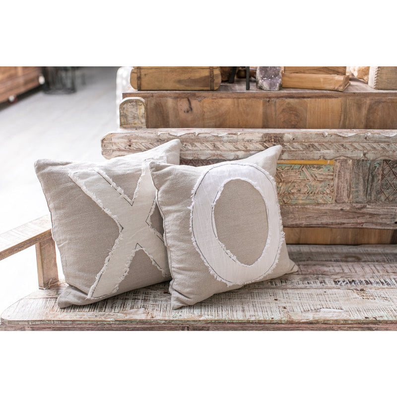 Stonewashed "X" Stitch Pillow by Sugarboo & Co. sits on a rustic bench for a vintage feel.